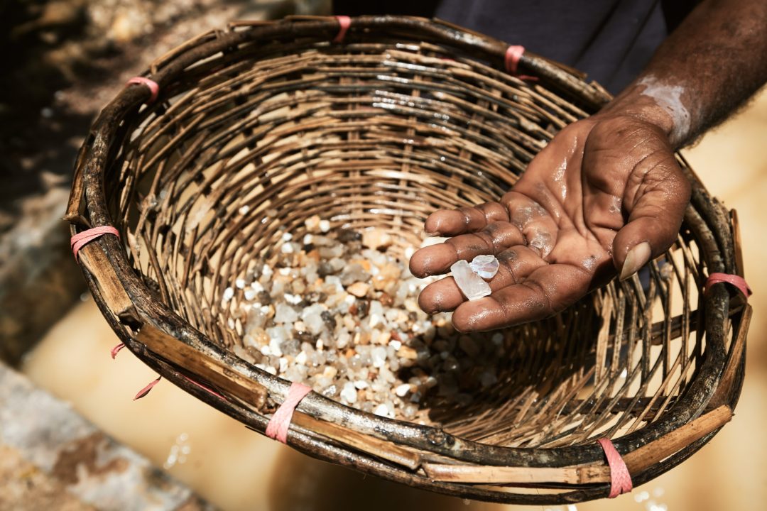 Worker showing gemostones found in Moonstone mine in Sri Lanka. This gemstones is later processed for making jewelry.